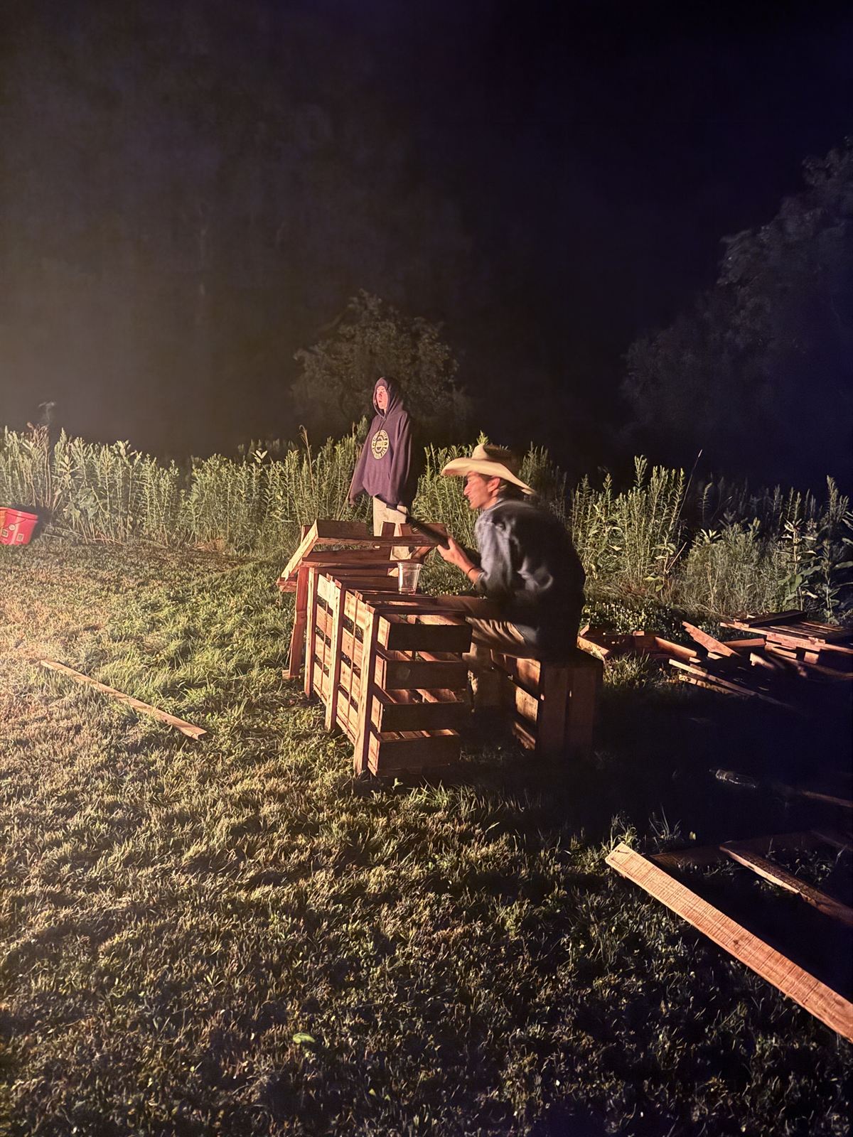 By the half-built pallet pile after dark