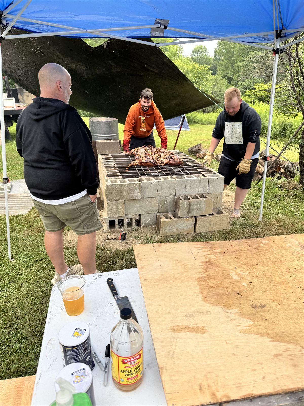 The hog on the pit with the crew around it