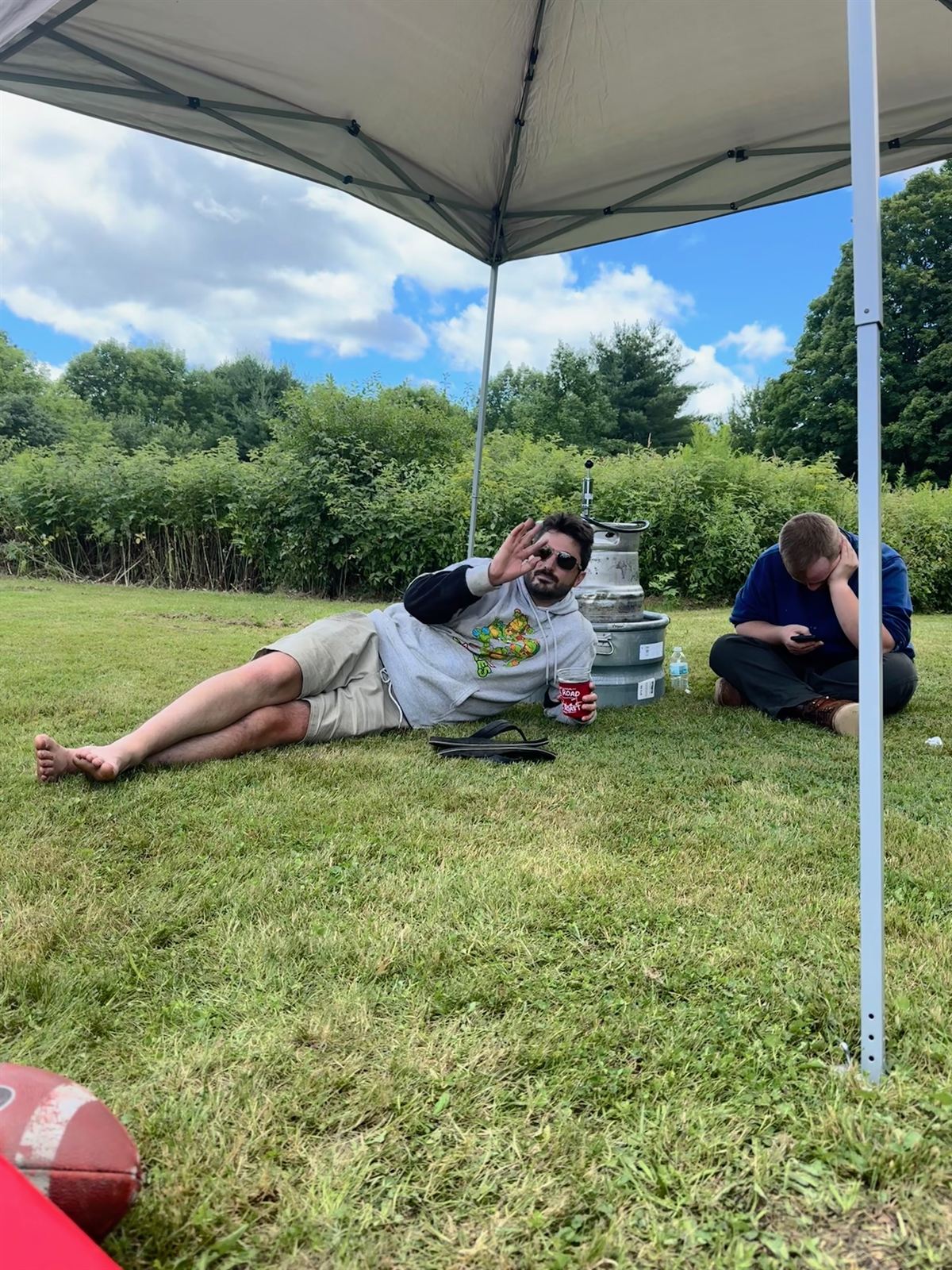 Stretched out on the grass under the canopy