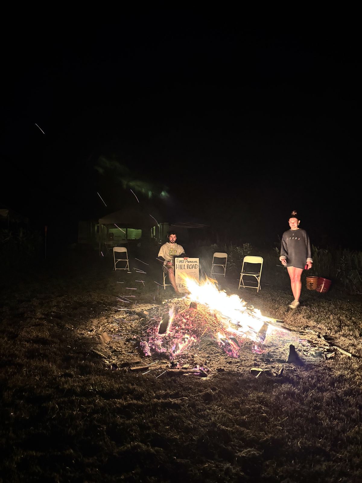 Holding the sign by the coals