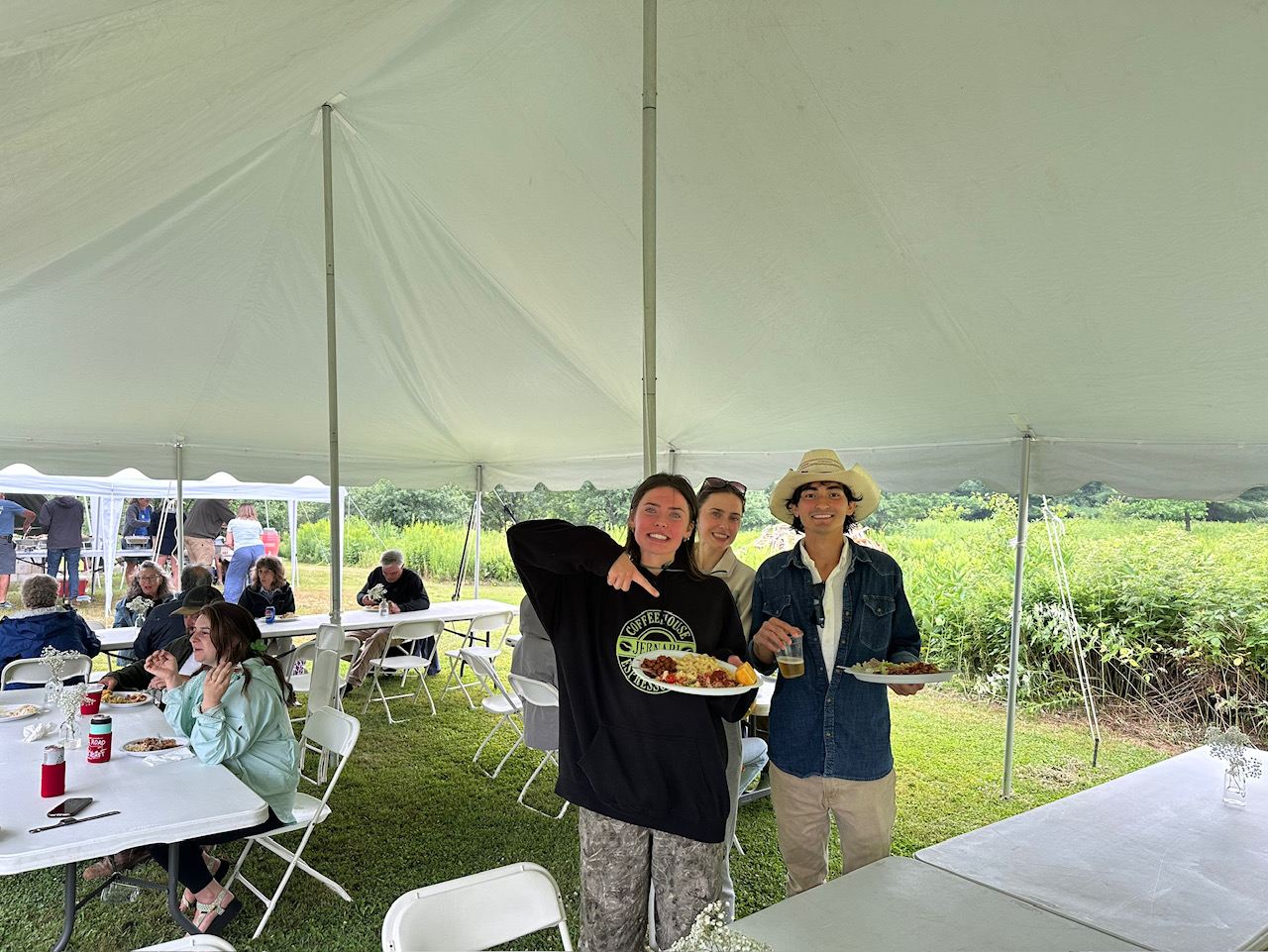 People with plates under the big tent